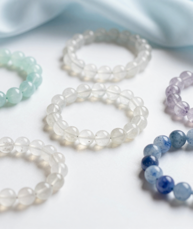 Air element crystal bracelets in aquamarine, clear quartz and blue lace agate on pale silk