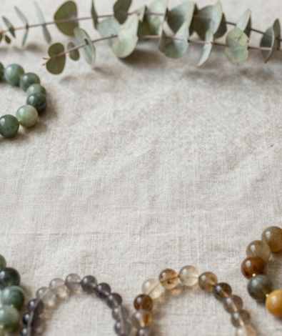 Earth element crystal bracelets in green jade, tiger's eye and moss agate on linen